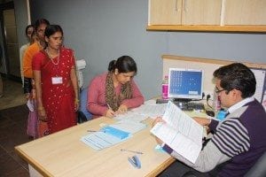 IndiaFactoryWorker SigningPaperwork 300x200 1