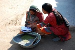 An Indian microfinance client reviewing paperwork