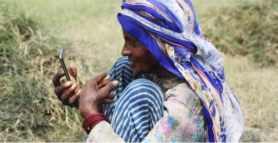 case study south asia women looking at phone outside