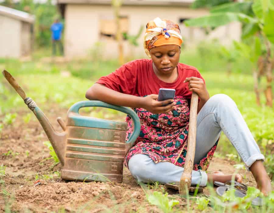 inclusive policy african woman on farm using phone